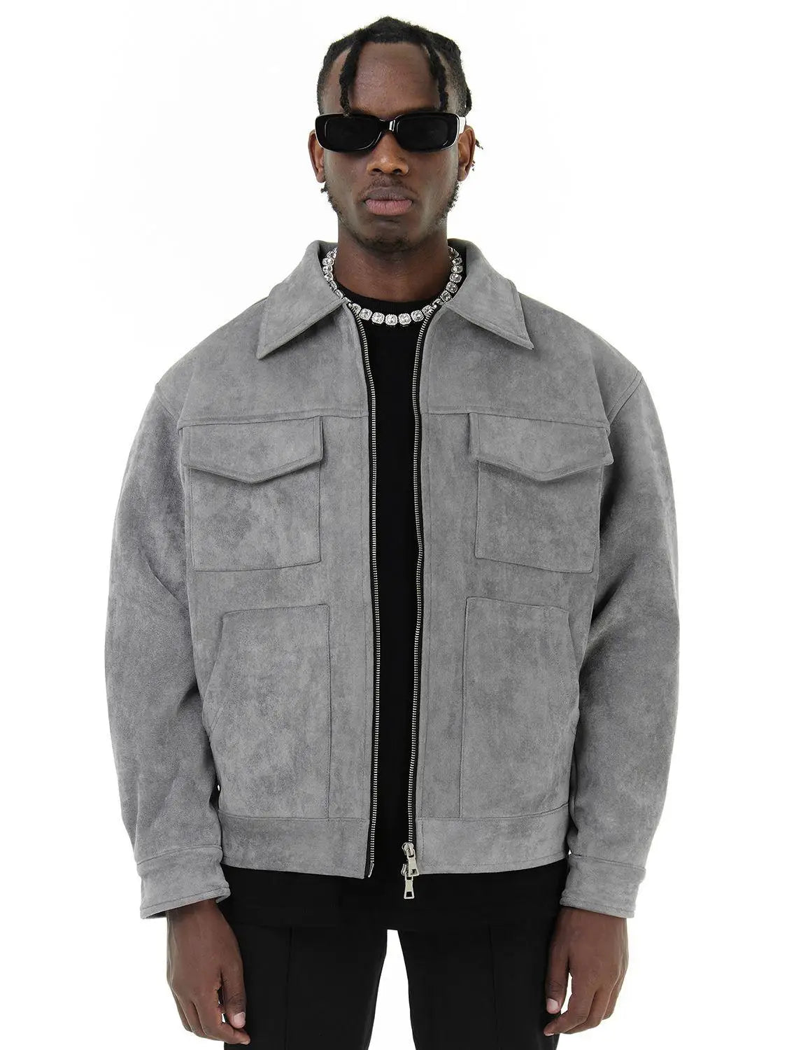 Man wearing a gray suede jacket on a white background